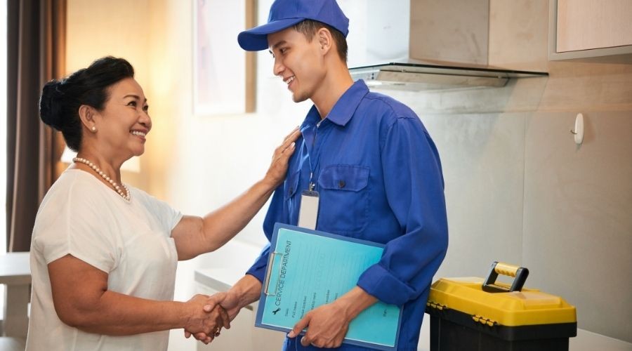 technician and homeowner shaking hands